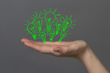 Sticker - Hands holding green nature in the light bulb