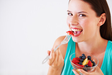 Sticker - I could eat fruit all day. Portrait of an attractive young woman enjoying a fruit salad.