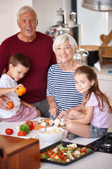 Sticker - Dinner will be ready in no time. Portrait of a grandparents preparing a meal with their grandchildren.