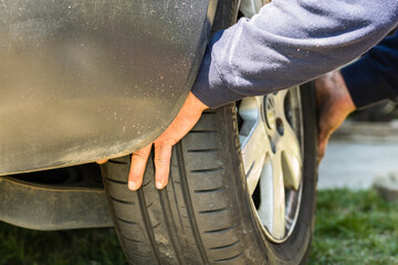 Car mechanic screwing or unscrewing car wheel by wrench at car garage in Bucharest, Romania, 2020