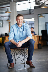 Poster - Love your job. Portrait of a young designer sitting in the studio.