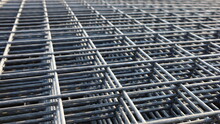 Steel Wire Mesh Pile. BRC Welded Wire Mesh For Slab Construction In Natural Light Top View. Selective Focus