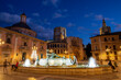 Valencia - The square Plaza de Mare de Deu with the Cathedral and church Basilica de la Mare de Deu dels Desamparats at dusk.