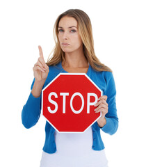 Wall Mural - Read the sign. Studio portrait of a stern-looking woman holding a stop sign.