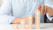 © Thapana_Studio - Interest rate and dividend concept, wooden block with percentage symbol and up arrow, return on stocks and mutual funds, long term investment for retirement.