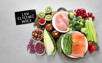Wall Mural - Foods with low glycemic index on gray background.
