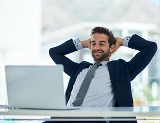 Poster - Business is a breeze. Shot of a young corporate businessman taking a break at an office desk.
