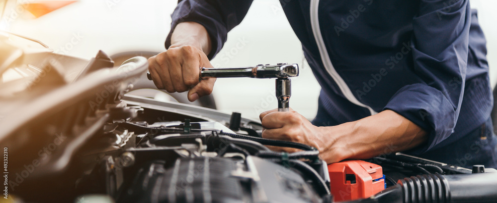 Automobile mechanic repairman hands repairing a car engine automotive workshop with a wrench, car service and maintenance,Repair service.