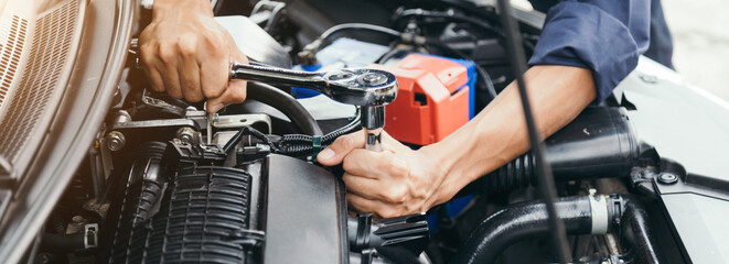 Automobile mechanic repairman hands repairing a car engine automotive workshop with a wrench, car service and maintenance,Repair service.