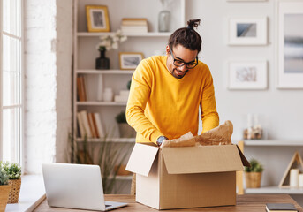 Black man unpacking carton box