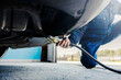 © Dusan Petkovic - Close up of a auto mechanic measuring exhaust gases on a car at workshop.