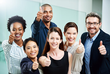 Poster - Stay positive, work hard and make it happen. High angle portrait of a group of businesspeople standing together and showing a thumbs up in the office.