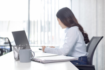 Wall Mural - Blurred image of a businesswoman, Asian businesswoman using laptop to private office at home, Freelancers work, Online communication, VDO Call , Home lifestyle.