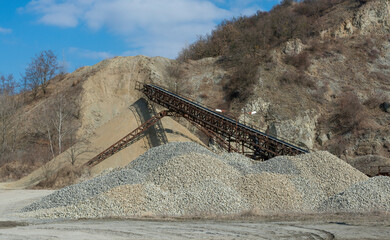 Conveyor belt at an old gravel quarry. Mining and quarrying equipment.