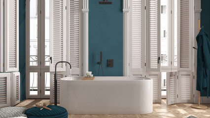 Modern bathroom in blue tones in classic apartment with window with shutters and parquet. Freestanding bathtub, pouf with accessories, rack with bathrobe. Minimalist interior design