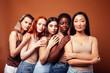 © iordani - young pretty asian, caucasian, african woman posing cheerful together on brown background, lifestyle diverse nationality people concept