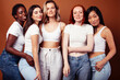 © iordani - young pretty asian, caucasian, african woman posing cheerful together on brown background, lifestyle diverse nationality people concept