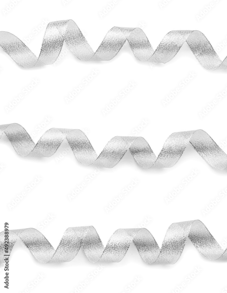 Curly silver ribbons on white background