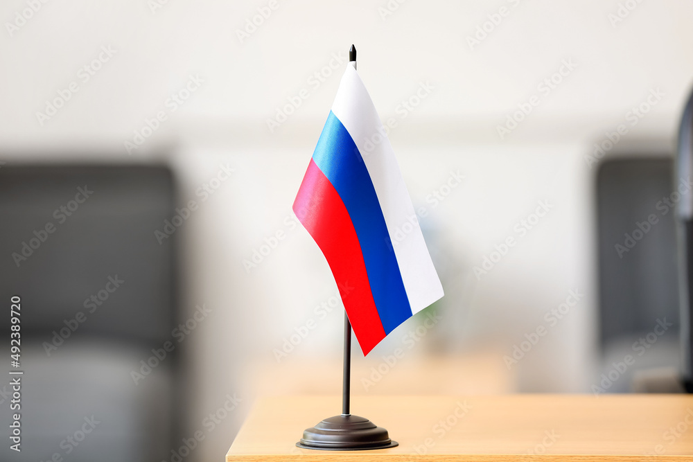 Russian flag on wooden table in room