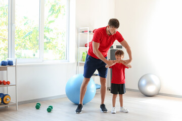 Poster - Male coach training with little boy in gym