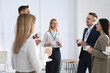 © New Africa - Group of people chatting during coffee break indoors