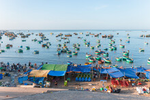 Colorful Round Vietnamese Fishing Boats In The Sea. Locals Sell Seafood