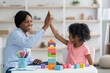 © Prostock-studio - Pretty preschool teacher exercising with happy little girl at kindergarten