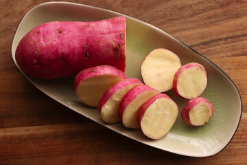 Sweet potatoes on wooden table