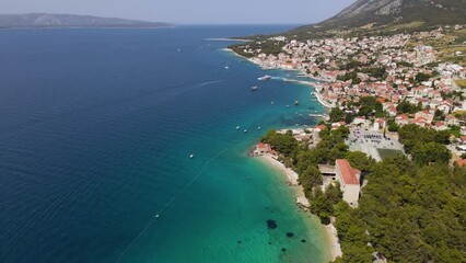 Wall Mural - Aerial view of Bol town with pebble beaches and Dominician monastery in Adriatic sea on Brac island, Croatia. 4k drone video. Summer vacation resort