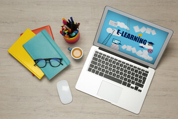 Modern laptop, cup of coffee and office stationery on wooden table, flat lay. E-learning