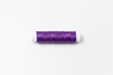 Close-up Of Purple Thread Spool Isolated On White Background. Very Peri Color.