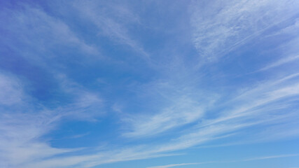 Wall Mural - white clouds and blue sky suitable for background or sky replacement.