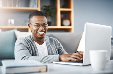 Poster - I stay connected so I dont miss out on anything. Portrait of a happy young man using a laptop while relaxing at home.