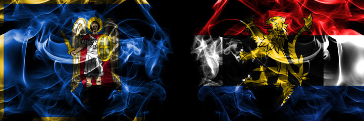 Kyiv, Kiev vs Benelux flag. Smoke flags placed side by side isolated on black background.