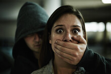 No, This Cant Be Happening. A Terrified Young Woman Held Captive By A Man With His Hand Over Her Mouth.