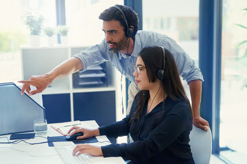 Canvas Print - Training a new employee about delivering quality service. Cropped shot of two call centre agents working together in an office.