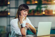 © Mediteraneo - Beautiful attractive woman at the cafe with a laptop having a coffee break