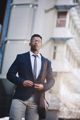 Poster - Hes well suited to be in the business game. Shot of a handsome young businessman in the city.