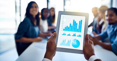 Poster - His team is going to love these numbers. Shot of an unidentifiable businessman holding up a tablet while sitting in a meeting with his colleagues.