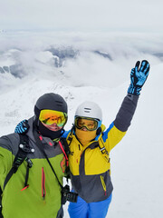 Wall Mural - couple skier and snowboarder taking selfie at the mountain top