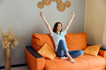 Wall Mural - cheerful woman on the couch rest fun Comfort apartments