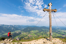 Female Hiker Admiring View From Bockstein With Summit Cross In Foreground