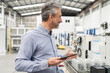 © Westend61 - Engineer holding tablet PC standing in factory