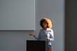 © Westend61 - Businesswoman giving speech at work place