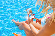 © Kaspars Grinvalds - Woman using video sharing social media app on mobile phone while sitting by the pool