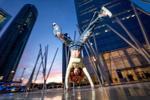 Woman Doing Handstand In Front Of Skyscrapers