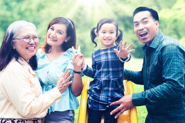 Wall Mural - Three generation family takes photo in playground