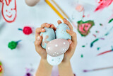 Fototapeta Mapy - Cute little child girl on Easter day hold easter egg in hand