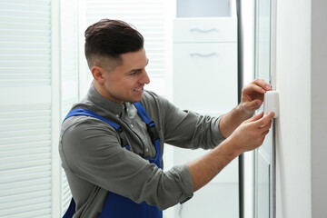 Canvas Print - Professional electrician repairing light switch in room