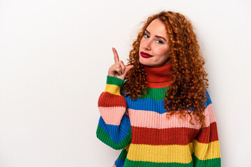 Young ginger caucasian woman isolated on white background showing number one with finger.